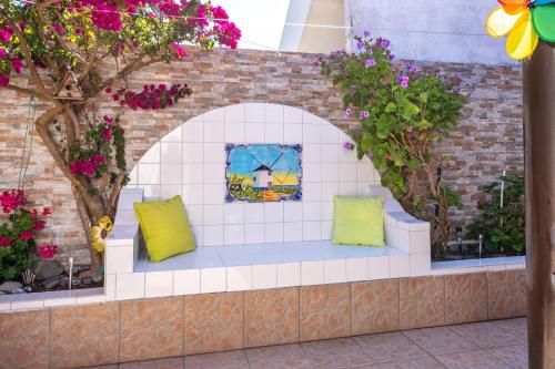 a bench in a garden with flowers and plants at Casa O Cantinho Algarvio in Odeceixe