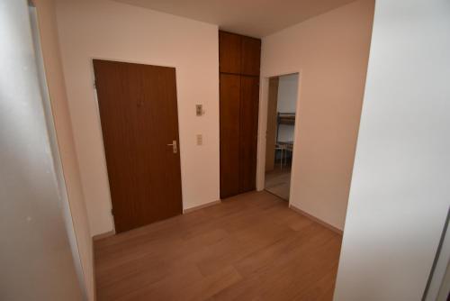 an empty room with two doors and a wooden floor at Ferienoase Köln- Frechen 3 Zimmer 70qm in Frechen