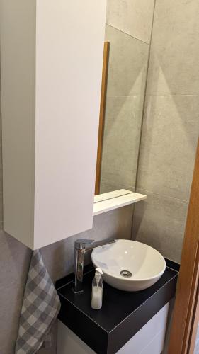 a bathroom with a white sink and a mirror at Ferienwohnung Azur Paradies Nordzypern in Küçükerenköy