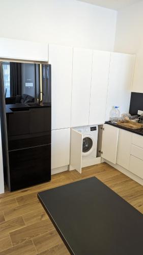 a kitchen with white cabinets and a washing machine at Ferienwohnung Azur Paradies Nordzypern in Küçükerenköy