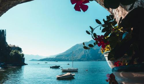 a view of a lake with boats in the water at Ostello Bello Lake Como in Como