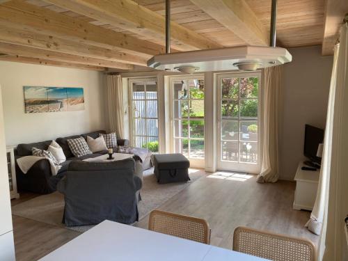 a living room with a couch and a table at Landliebe in Oldsum