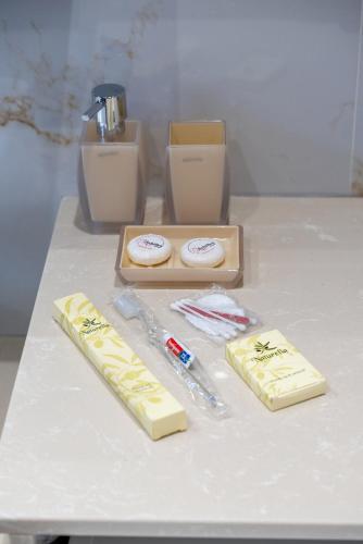 a counter with two pieces of butter and toothbrushes at Brikis Villa 2 - With Private Pool in Balíon