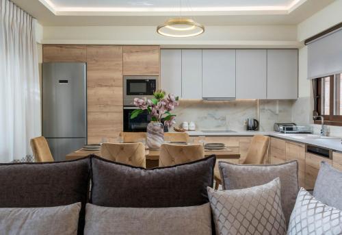 a kitchen and living room with a table and chairs at Brikis Villa 3 - With Privae Pool in Balíon