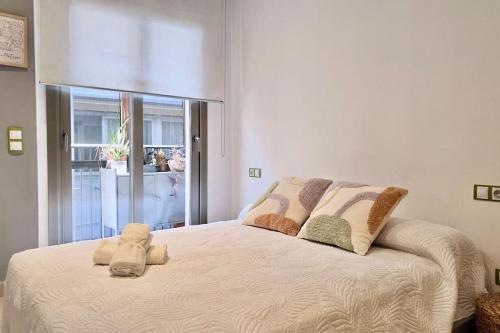 a bedroom with a large bed with pillows on it at Penthouse 100m from Sea with Terrace, Near BCN in Mataró