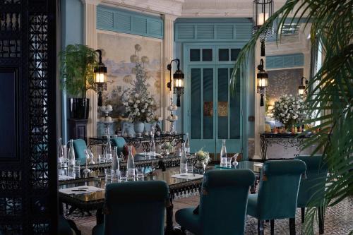 a dining room with a table and chairs at Palais Ronsard Relais & Chateaux in Marrakech