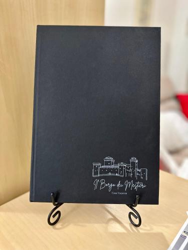 a black card with a drawing of a train at Il Borgo dei Mestieri in Spoleto