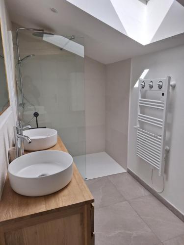 a white bathroom with a sink and a mirror at Au Cœur Des Champs in La Petite-Boissière
