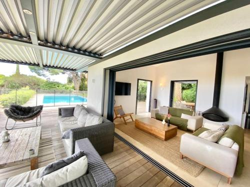 un salon meublé et une piscine dans l'établissement Magnifique villa vue mer, à Sainte-Maxime