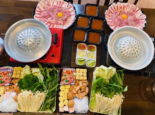 a table topped with different types of food on plates at Doichang view-Sunset room in Ban Huai Khai