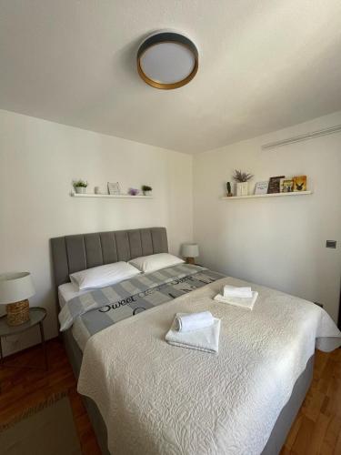 a bedroom with two beds and a mirror on the ceiling at House Old Town Trogir in Trogir