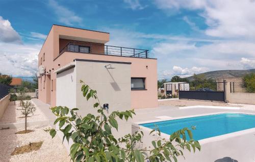 a house with a swimming pool next to a building at Holiday Home Tina in Oklaj