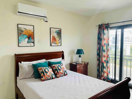 a bedroom with a bed with pillows and a window at Vae Luxury Paradise - Free Beach&Pool Access in Allen Hall
