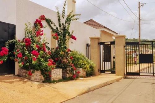 a house with flowers in front of a gate at Vae Luxury Paradise - Free Beach&Pool Access in Allen Hall