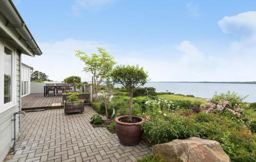 a patio with a view of the water at Gorgeous Home In Ølsted With Kitchen in Ølsted