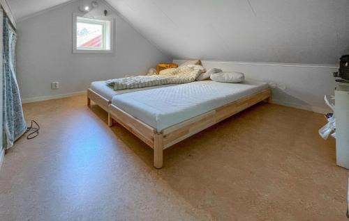 a bedroom with a bed in the corner of a room at 4 Bedroom Lovely Home In Fagerfjäll in Gåseknöde