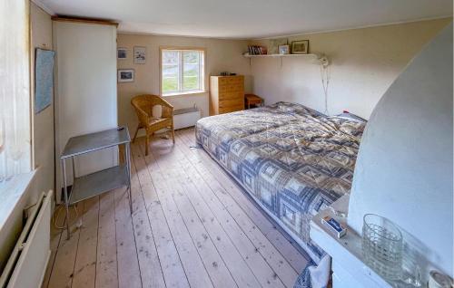 a bedroom with a bed and a desk and a chair at 4 Bedroom Lovely Home In Fagerfjäll in Gåseknöde