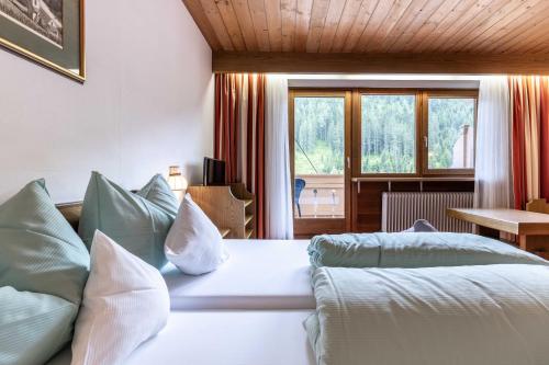 Postel nebo postele na pokoji v ubytování keyone rooms Gerlos