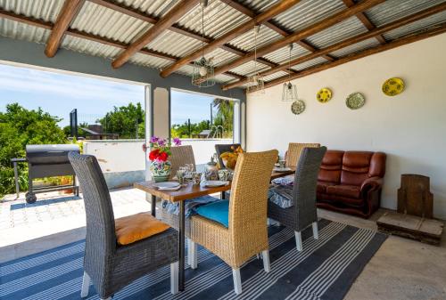 a dining room with a table and chairs at Casa D'Nossa, casa tradicional e Moderna, vista 360º, piscina de agua salgada in Luz de Tavira