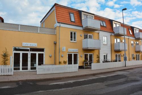 a yellow building on the side of a street at Hotel Marie in Skagen