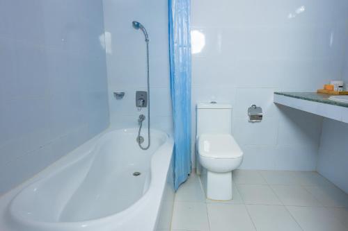 a bathroom with a toilet and a tub and a sink at Kathmandu Business Hotel in Kathmandu