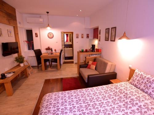 a room with a bed and a living room at Apartments Antonella in Zagreb