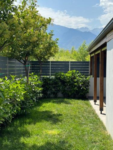 a backyard with a fence and a tree and grass at Luxury Villa Plaka Litochorou with Pool in Plaka Litochorou