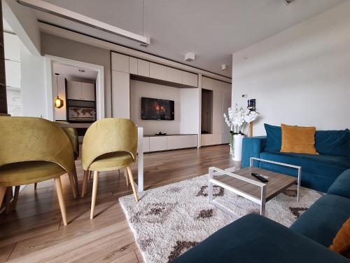 a living room with a blue couch and chairs at Panoramic view-Excelent location in Arad
