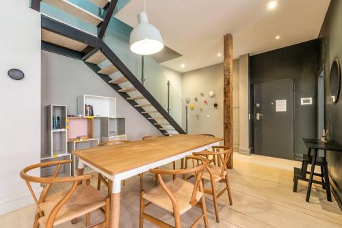 a dining room with a wooden table and chairs at GuestReady - Newly Renovated 3BR Apartment – Chiado in Lisbon