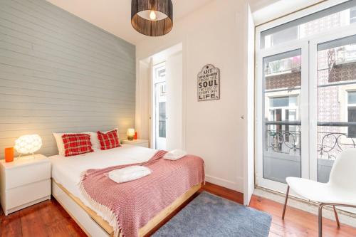 a bedroom with a bed and a window at GuestReady - Fantastic w Big Patio – Bairro Alto in Lisbon