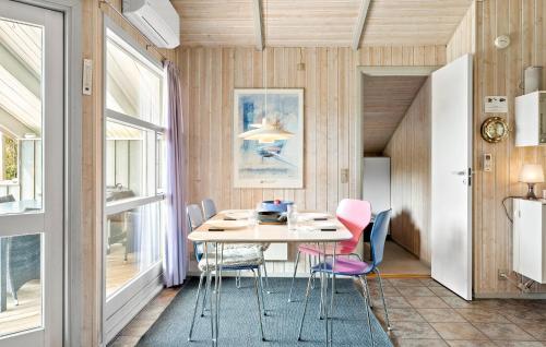 a dining room with a table and chairs at Holiday Home Østersvej Fjerritslev Xii in Slettestrand