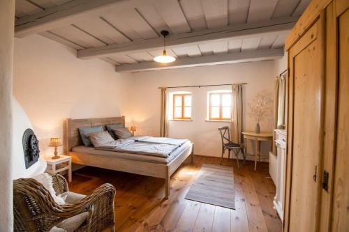 a bedroom with a bed and a table and chairs at Templomdomb Vendégház Dunakanyar in Pilismarót