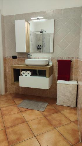 a bathroom with a sink and a mirror at Villa DolceVita in Fregene