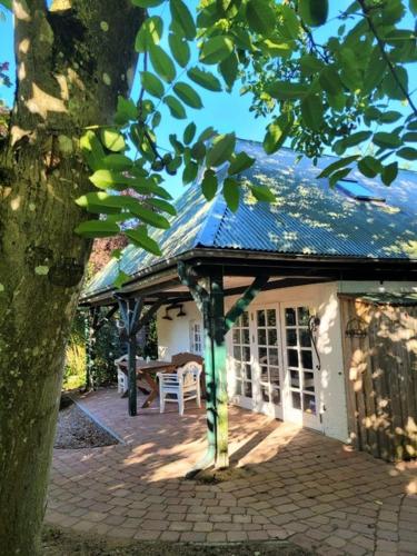 a house with a roof and a patio with a table at Lille Skov in Rabenkirchen