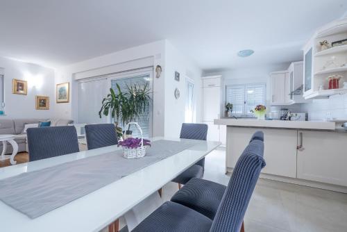 a kitchen and dining room with a table and chairs at Sandrina Residences in Vrsi