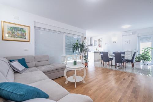 a living room with a couch and a table at Sandrina Residences in Vrsi