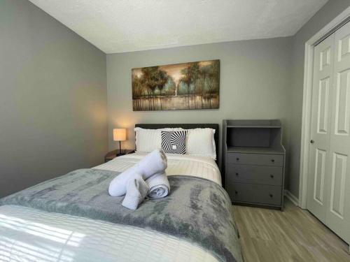 a bedroom with a bed with white sheets and pillows at Discover Charm City from a Cozy Retreat in Baltimore