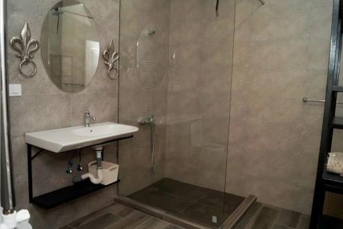 a bathroom with a sink and a shower with a mirror at New house in Jrvezh in Yerevan