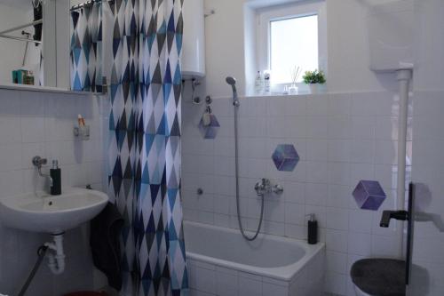 a bathroom with a shower and a sink and a toilet at Apartman ZORA s bazenom in Mostar