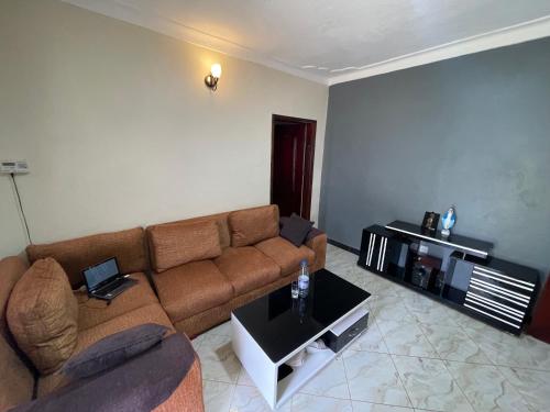 a living room with a couch and a table at Urban Hues Holiday Home in Kampala