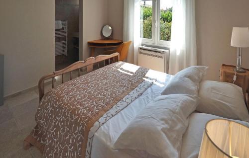 a bed sitting in a room with a window at Villa Les Sapins in Moulès