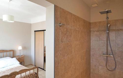 a bathroom with a shower and a bed in a room at Villa Les Sapins in Moulès
