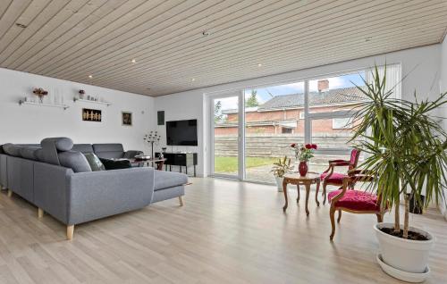 a living room with a couch and a table at Amazing Home In Aars With Wifi in Års