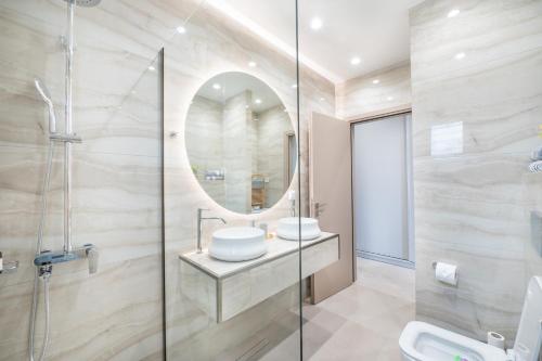 a bathroom with a sink and a mirror at THEA Seaview Luxury Living in Kalamata