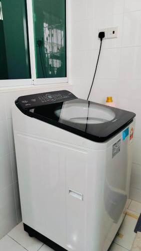 a machine with a laptop on top of it at Nyaman Sweet Home in Balik Pulau