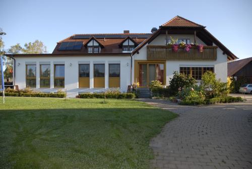a house with a pathway in front of it at Gasthaus-Pension Hofmann in Oberdachstetten
