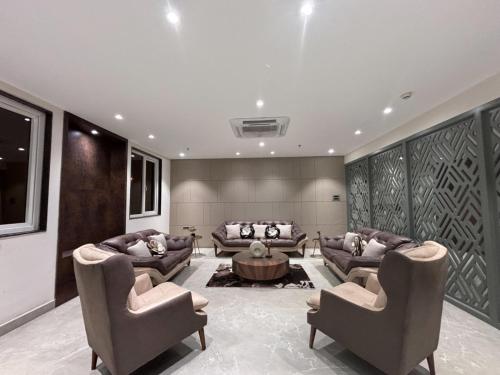 a living room with two couches and a table at Rohika AAU-IGH in Guwahati