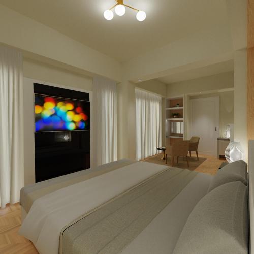 a bedroom with a large bed and a flat screen tv at Versilia Palace Hotel in Marina di Pietrasanta