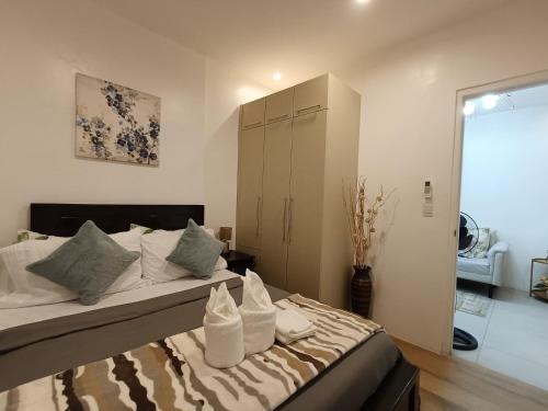 a bedroom with a large bed and a cabinet at 2bedrooms 2toilet& bath Matina Enclaves Condo in Davao City