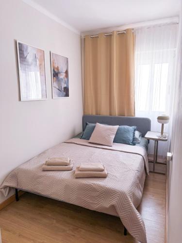 a bedroom with a large bed with two pillows on it at Studio Aiora in Valencia